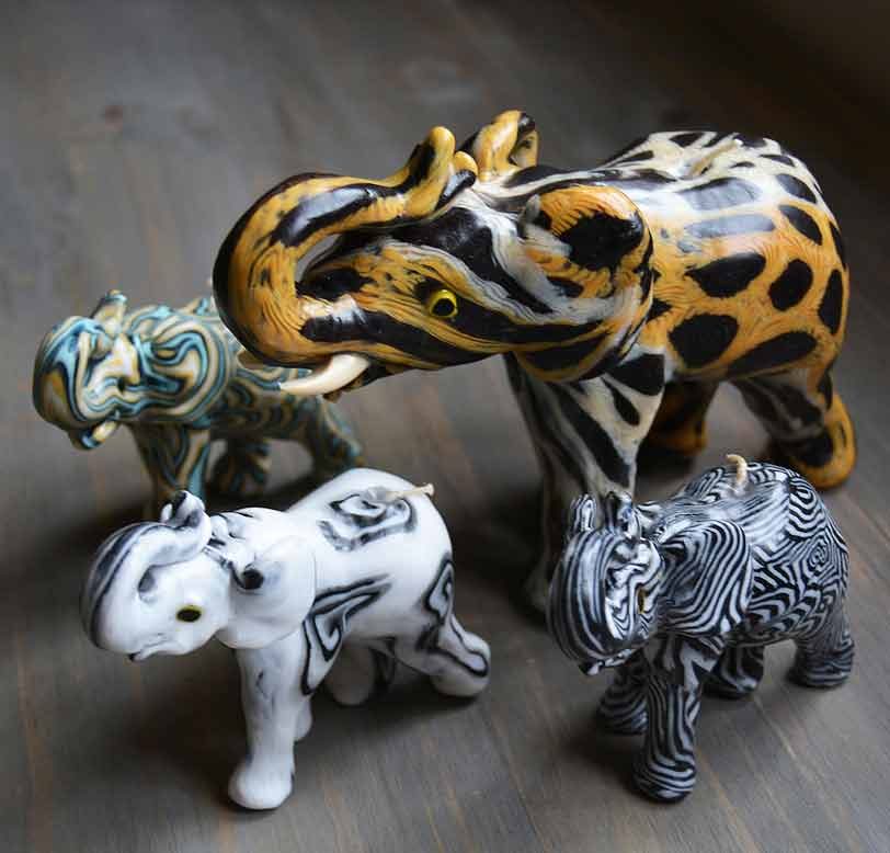 Hand-carved animal-shaped Swazi Candles including an elephant, zebra and rhino in vivid millefiore patterns