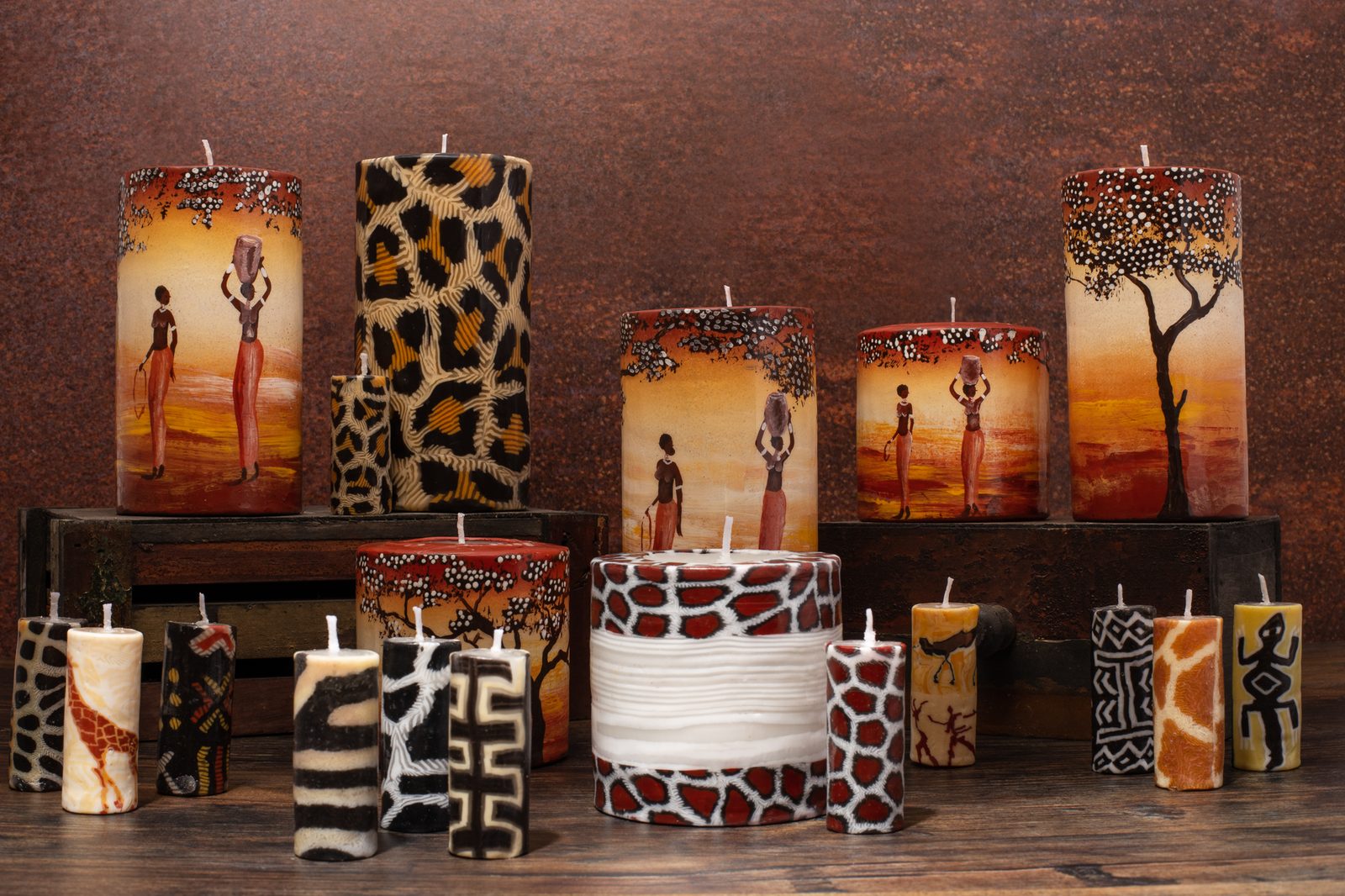 Collection of hand-painted Swazi Candles pillar candles with African sunset and animal-print designs
